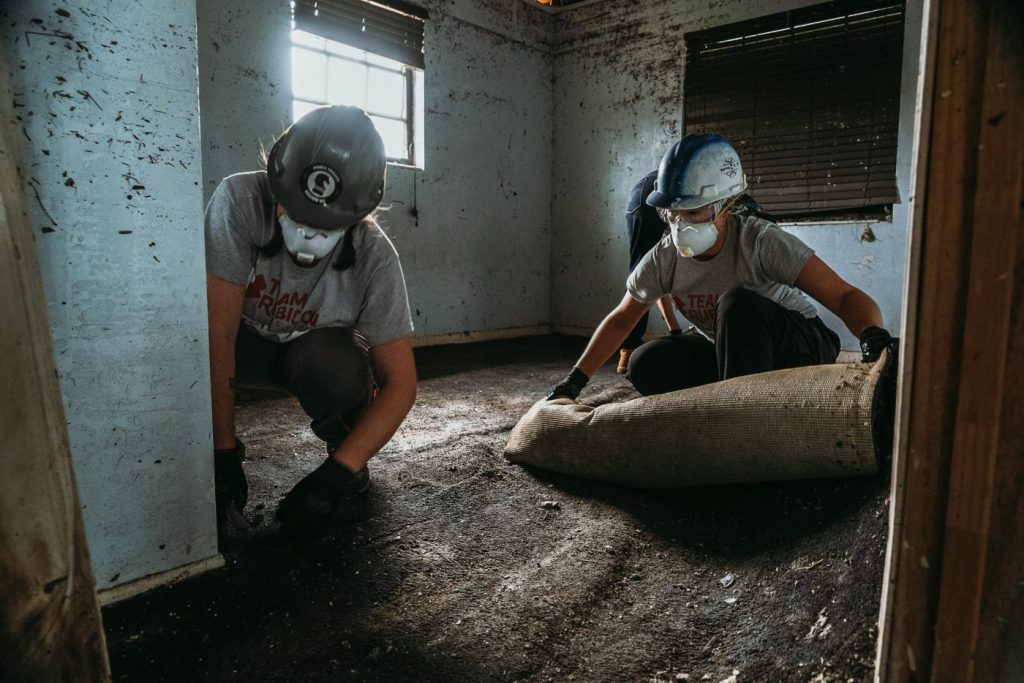 Greyshirts show How to Clean Up After a Flood as they tear out carpeting