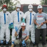 volunteers in Tyvek practice flood cleanup safety